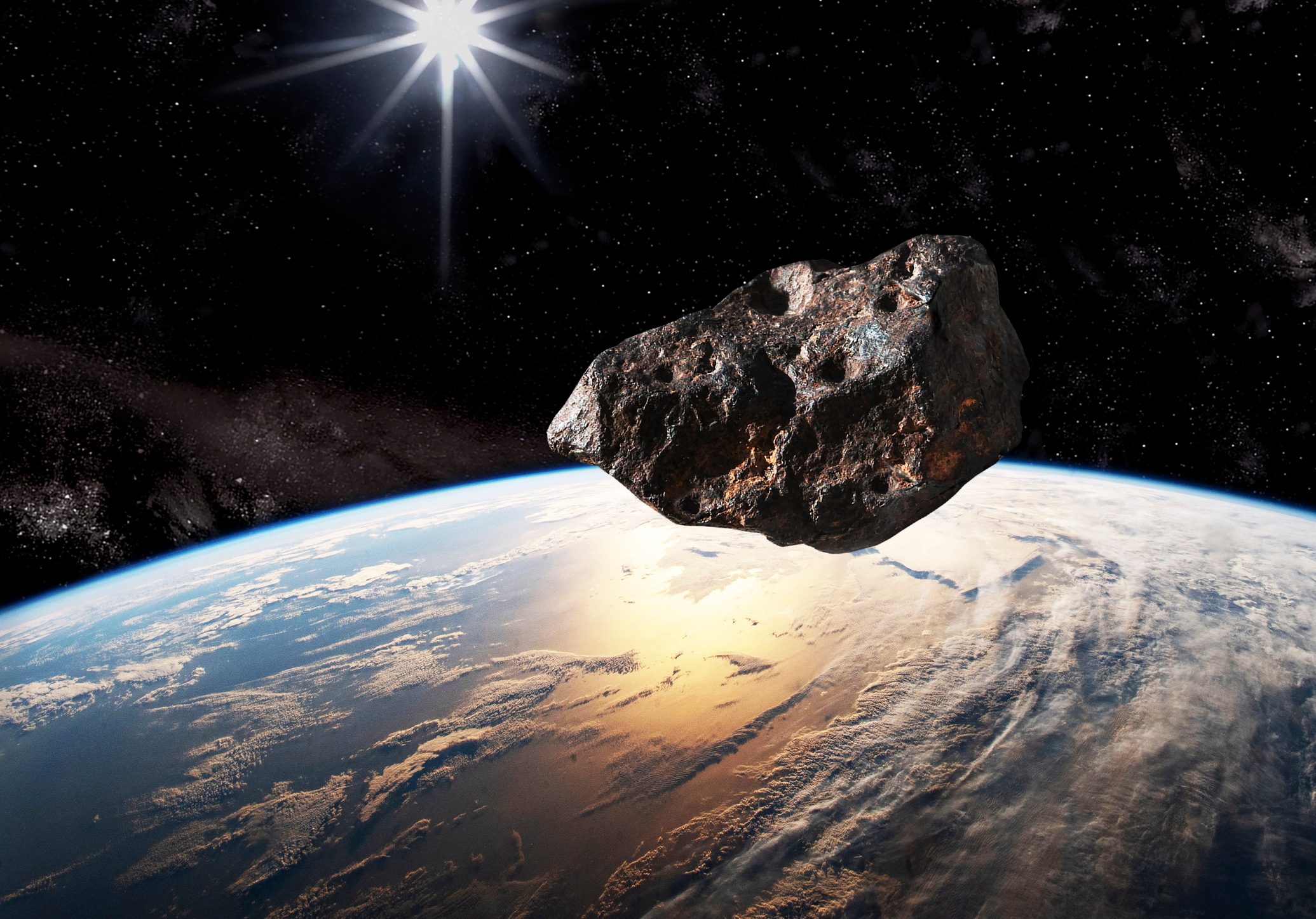 The represented asteroid is a studio photograph of an actual (3" long) meteorite, with added impact craters with PhotoShop to simulate a larger scaled-up asteroid.