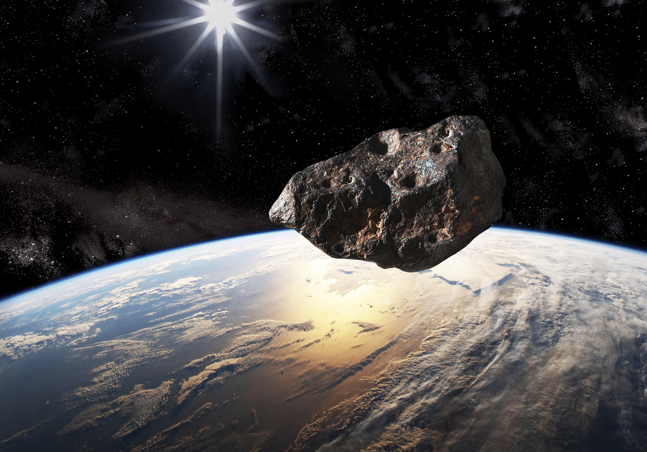 The represented asteroid is a studio photograph of an actual (3" long) meteorite, with added impact craters with PhotoShop to simulate a larger scaled-up asteroid.
