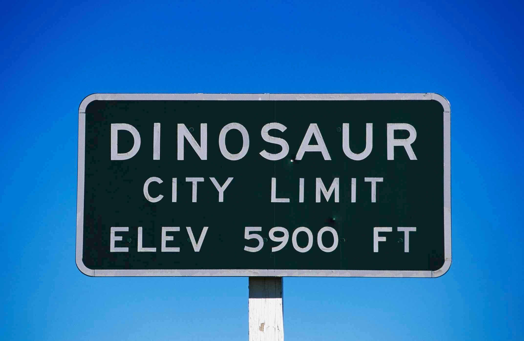 Dinosaur city limit sign