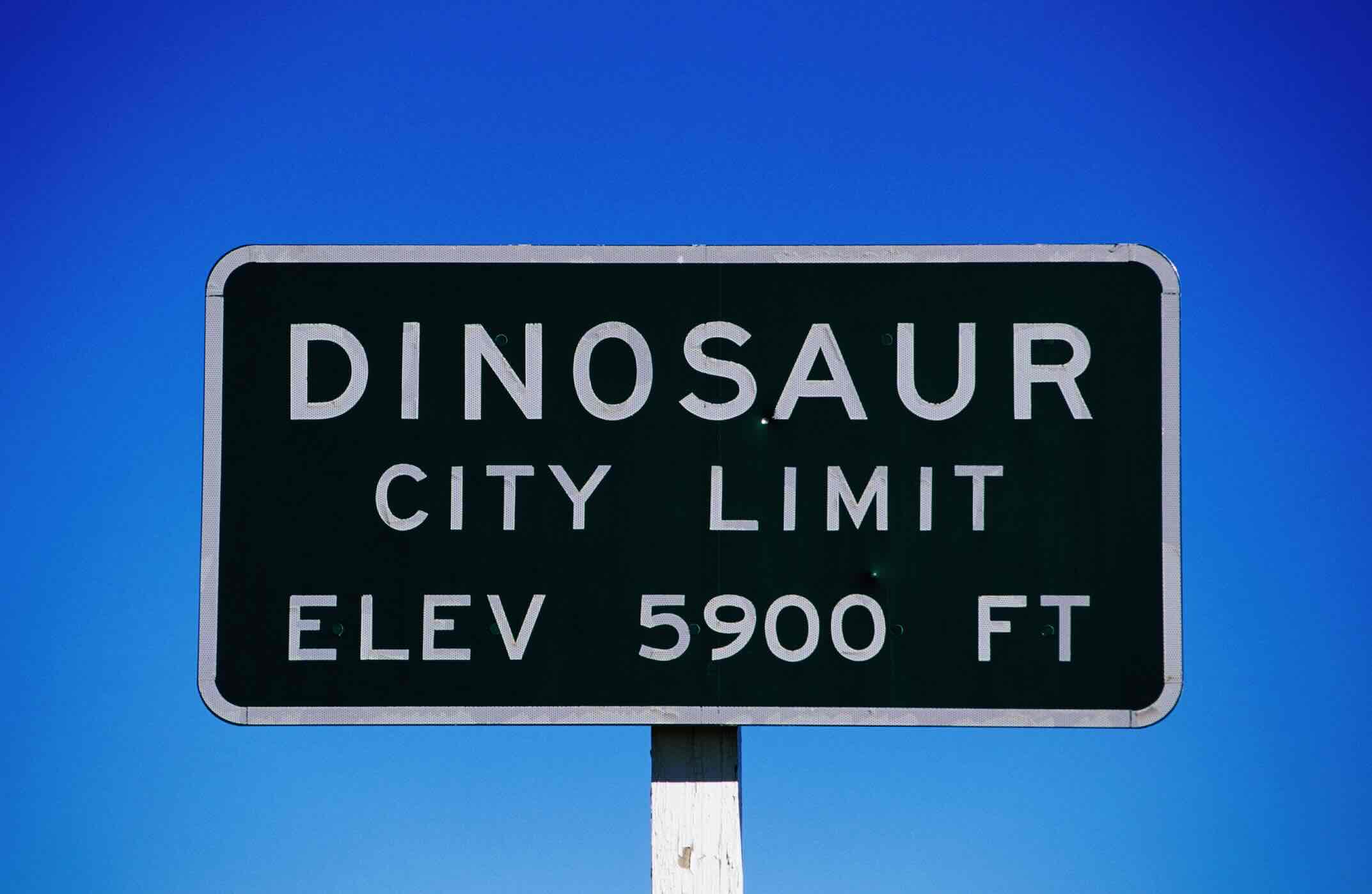 Dinosaur city limit sign