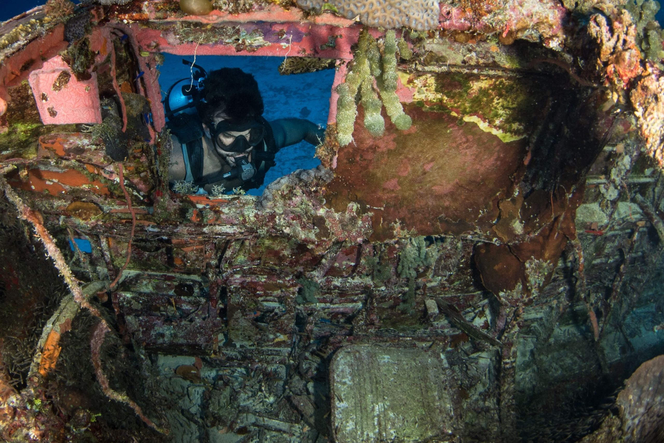 Diver looking inside WWII airplane
