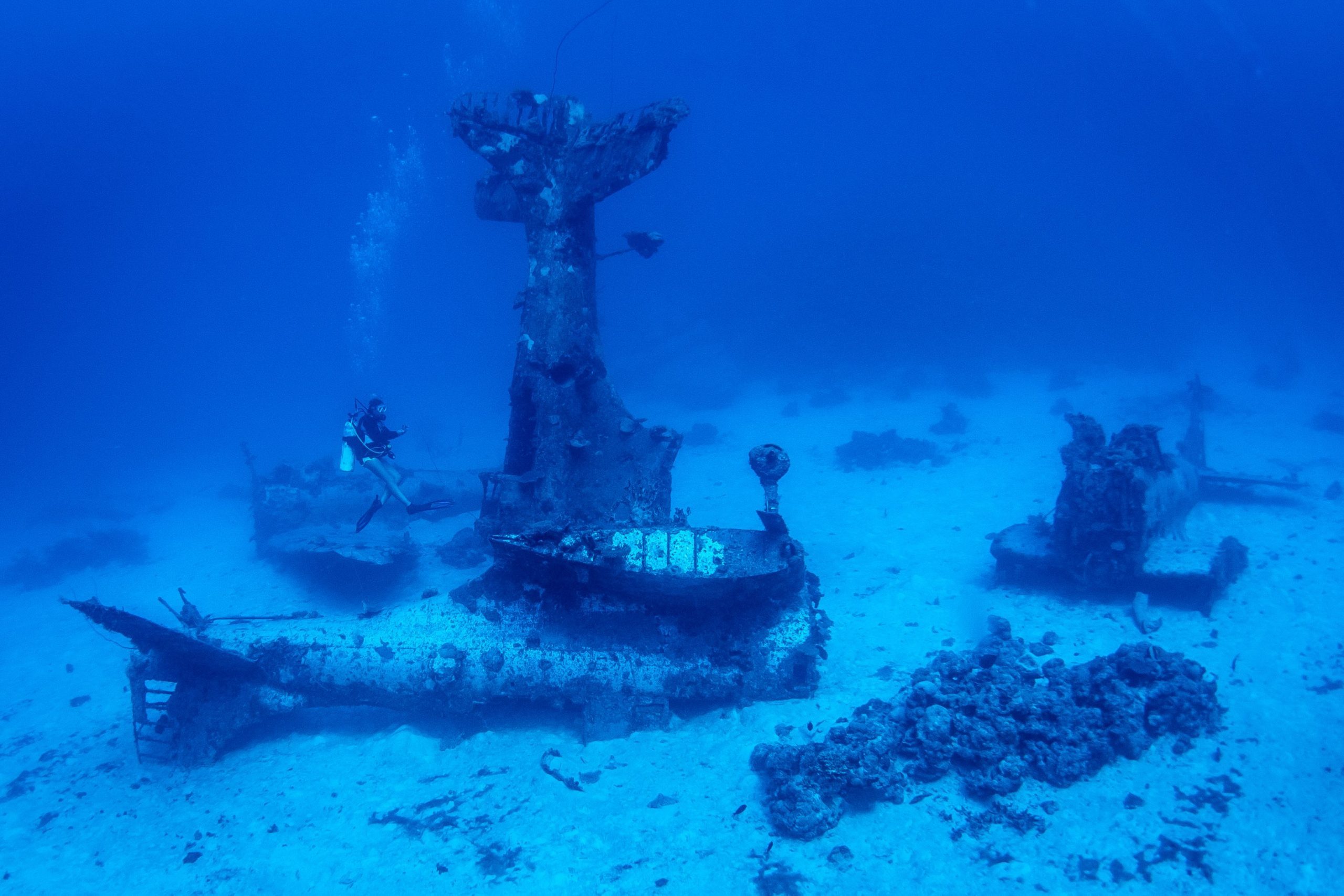 Diver over WWII Douglas Dauntless airplanes